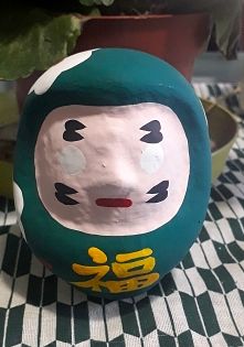Daruma bambola votiva di colore verde