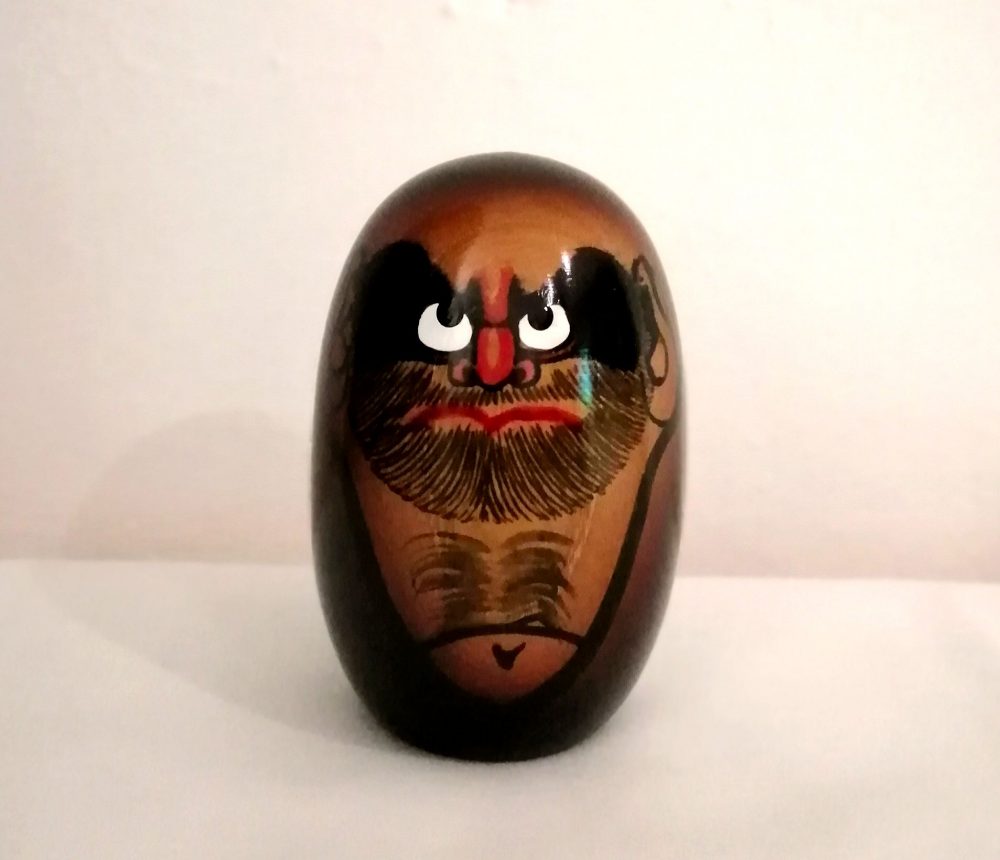 Kokeshi a forma di daruma, di colorazione marrone dipinta a mano su legno realizzata dall'artista Seifu Gono